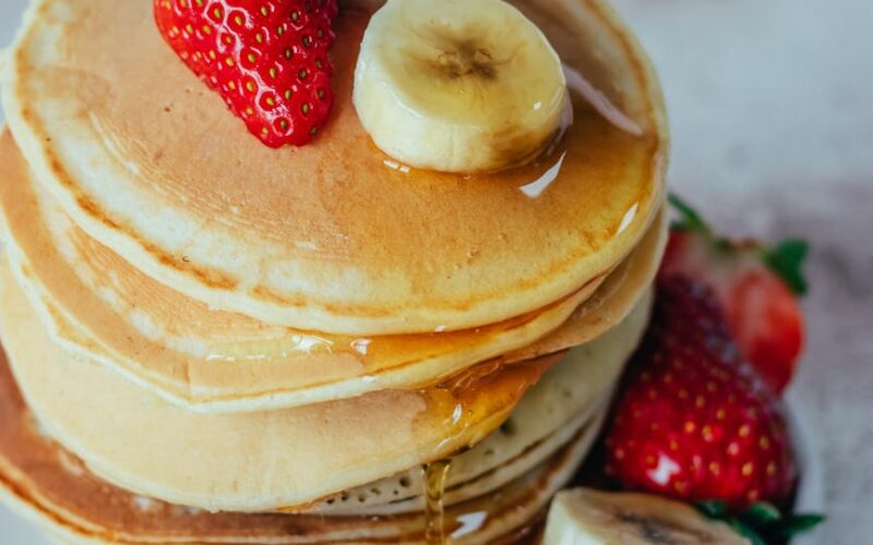 delicious pancake stack with fresh fruits and syrup