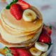 delicious pancake stack with fresh fruits and syrup